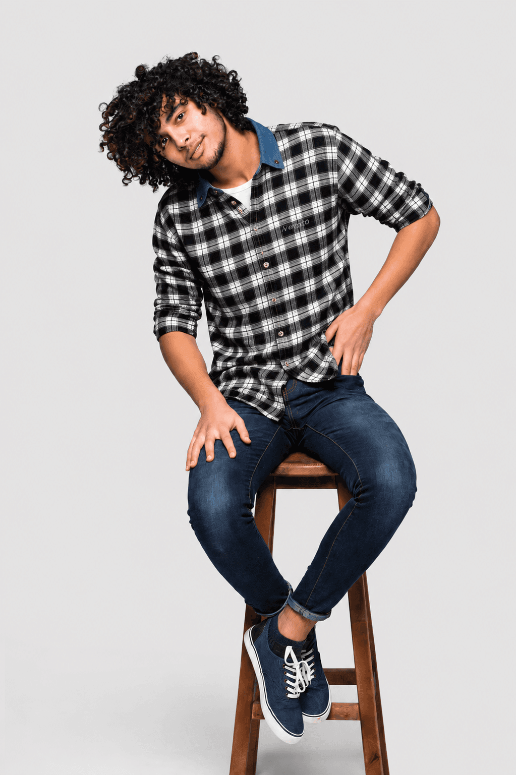 Model wearing a black and white checkered flannel shirt