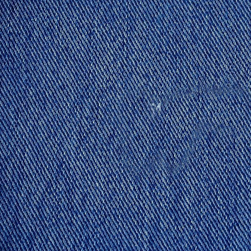 Close-up of blue denim fabric showing its diagonal weave
